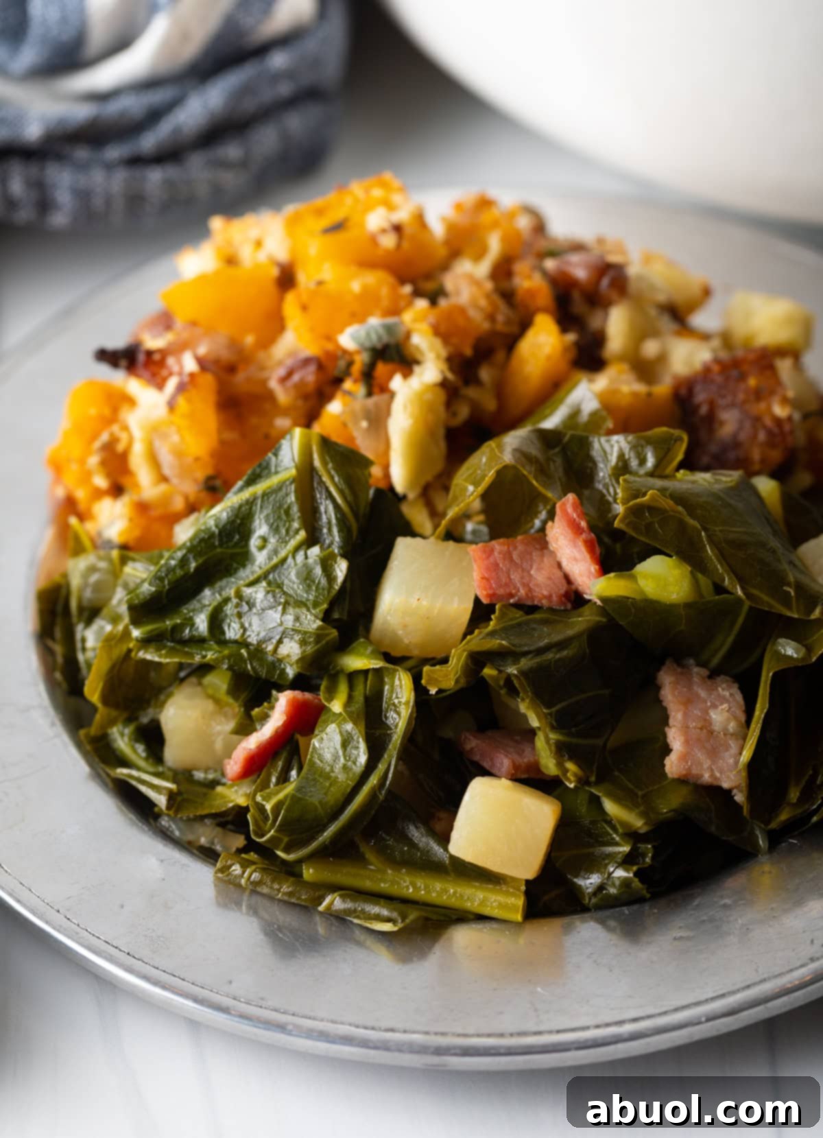 A rustic plate featuring perfectly stewed Southern greens, highlighted by the rich, dark broth and tender leaves, ready for a comforting meal.