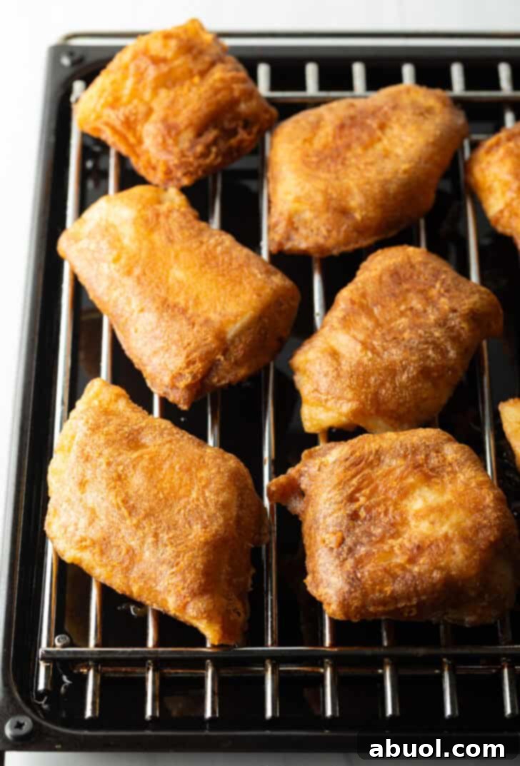 Several pieces of fried fish on a wire rack.