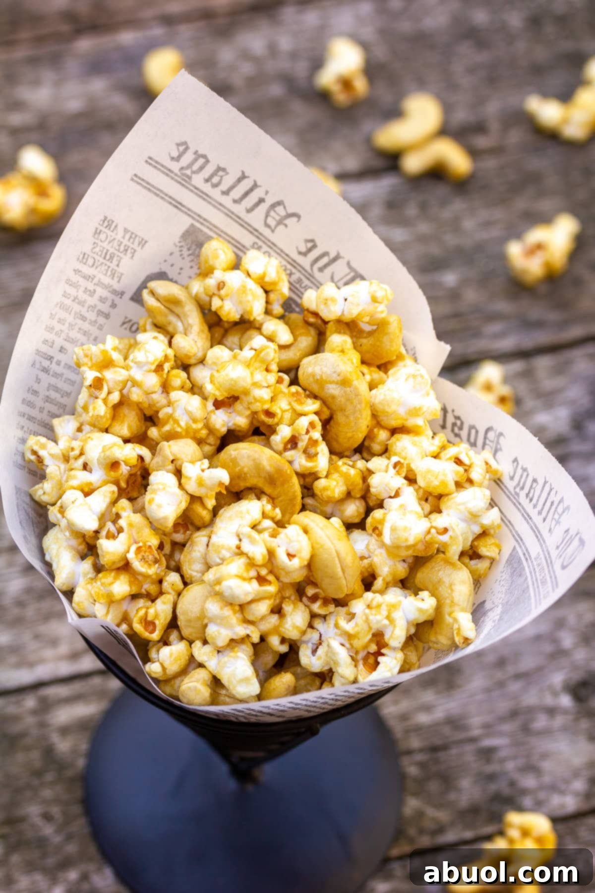 Easy Microwave Caramel Popcorn Microwave caramel popcorn recipe shown in a charming paper cone, ready to be enjoyed or gifted.
