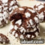 Mexican Mocha Crinkle Cookies Recipe stacked on plate with bite taken out of top cookie