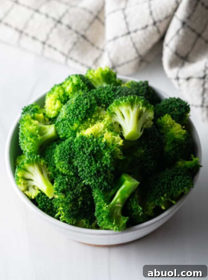 A bowl of vibrant green, perfectly boiled broccoli ready to be incorporated into a meal.