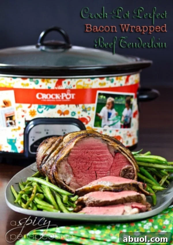 Crockpot Bacon Wrapped Beef Tenderloin Recipe with Balsamic Glaze sliced on platter with green beans and fresh herbs