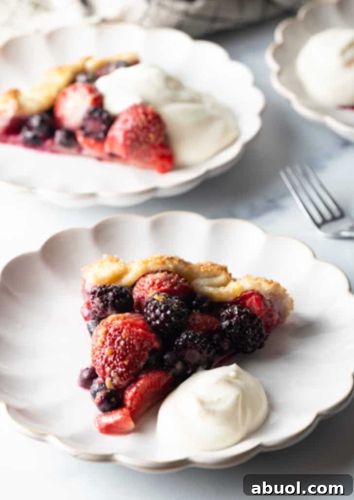 A final, irresistible image of a berry crostata slice, beautifully plated with ricotta cream, inviting you to take a bite.