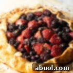 Baked crostata with blueberries, blackberries, and strawberries.