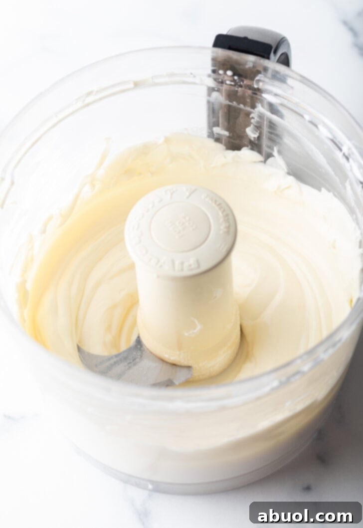 Making creamy ricotta topping in a food processor.
