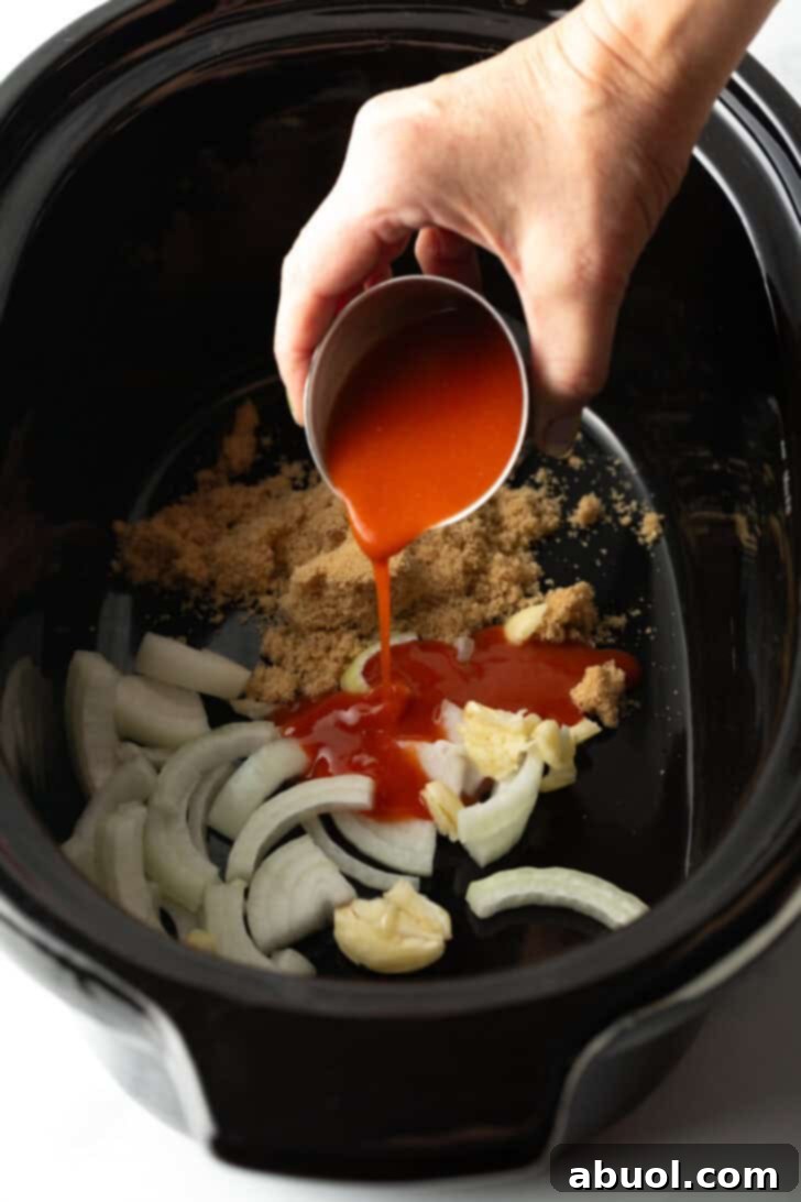 A closer view of pouring hot sauce from a small metal cup, ensuring precise measurement for the desired level of spice.