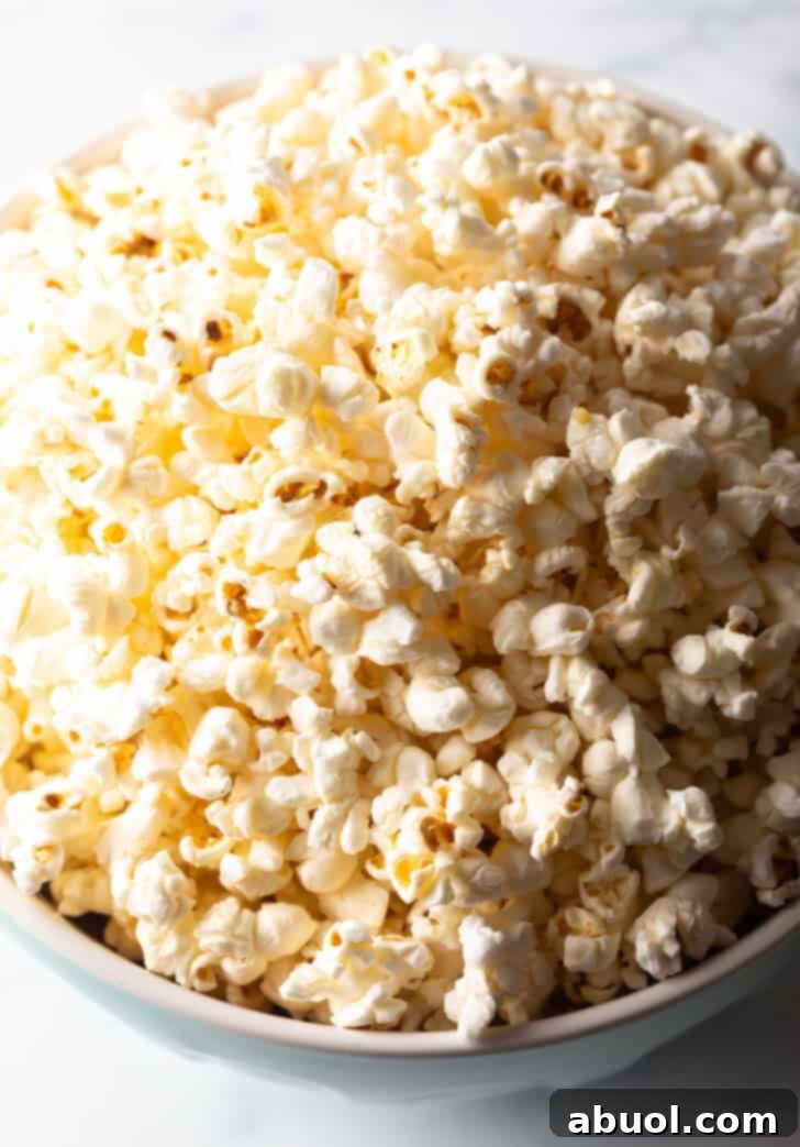 Top down view buttery ghee popcorn in a blue bowl.