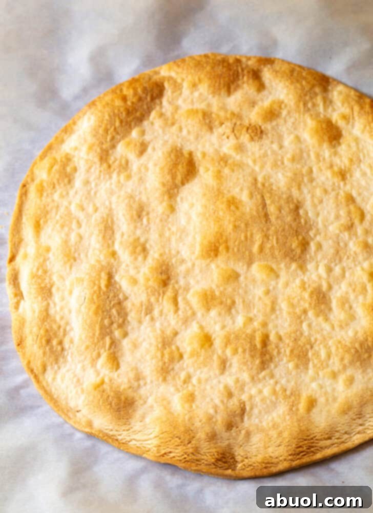 Large circular piece of baked pie crust, golden brown and crisp.