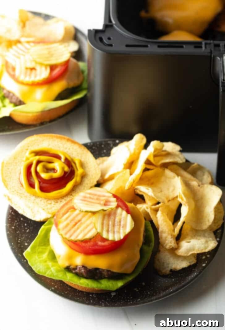 Air Fryer Burger Perfection 10 Top down view open faced cheeseburger on a plate with potato chips.