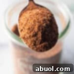 Spoonful of chicken taco seasoning held to camera.