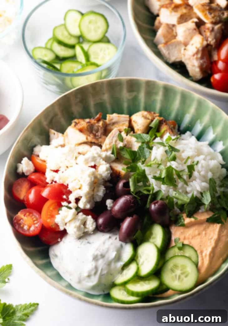 Top-down view of a vibrant Mediterranean chicken bowl, showcasing all its components beautifully arranged.