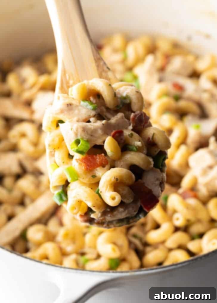 A spoonful of chicken bacon ranch pasta held to the camera, ready to be enjoyed.
