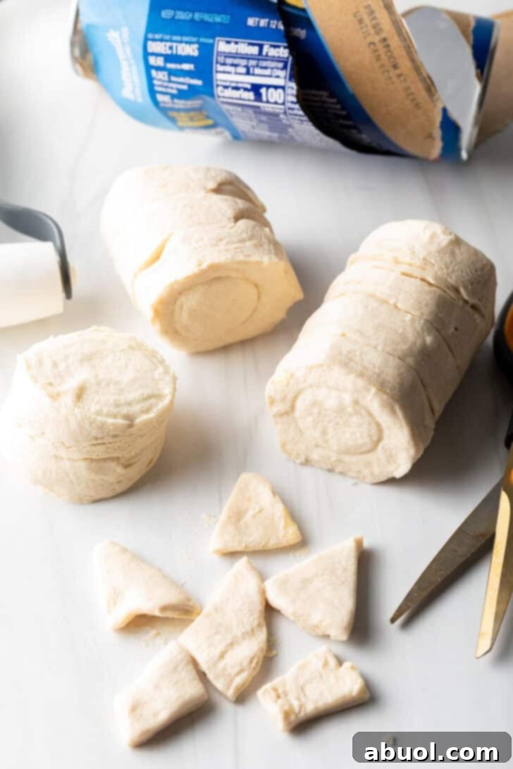 Pieces of biscuit dough cut into small triangles.