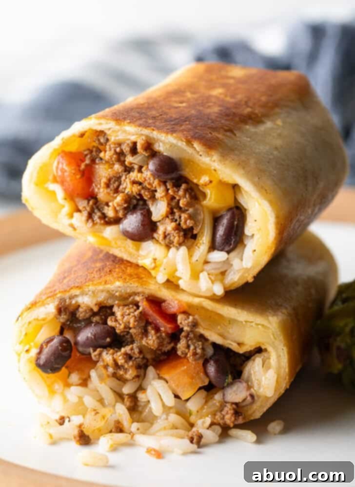 Two halves of a beef and cheese burrito stacked on top of each other.