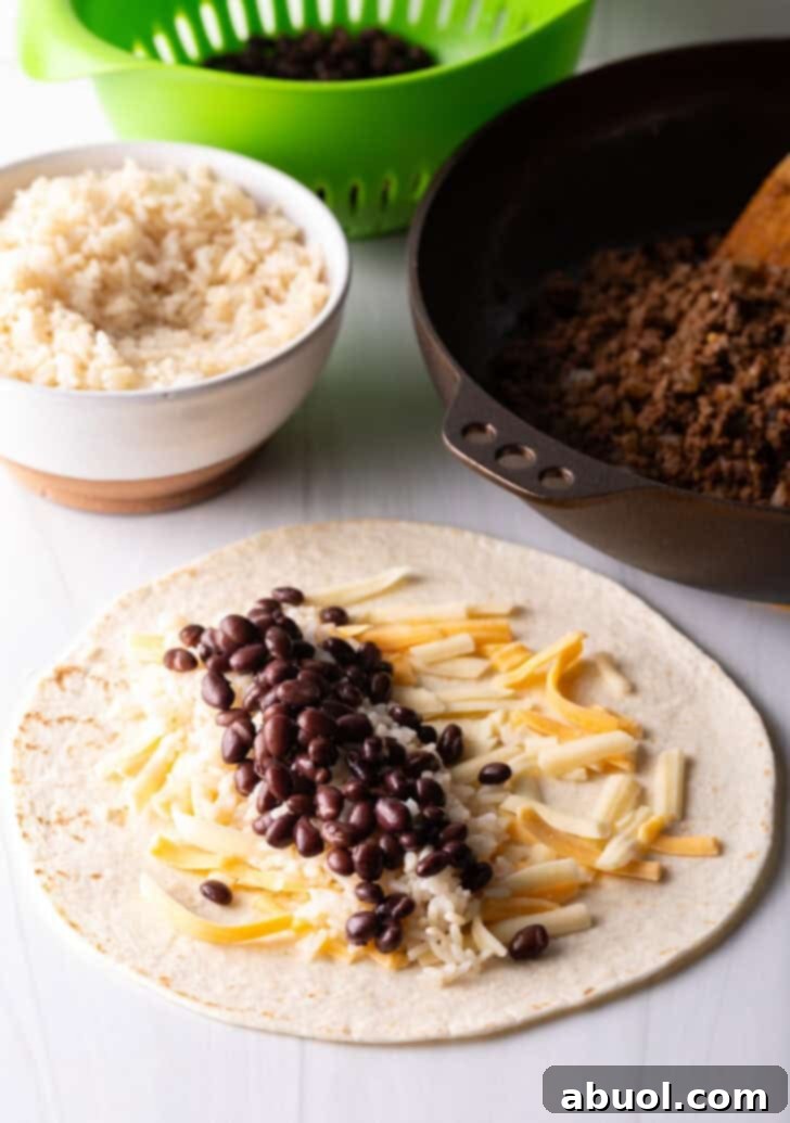 Open-faced flour burrito with shredded cheese, beans, and ground beef.
