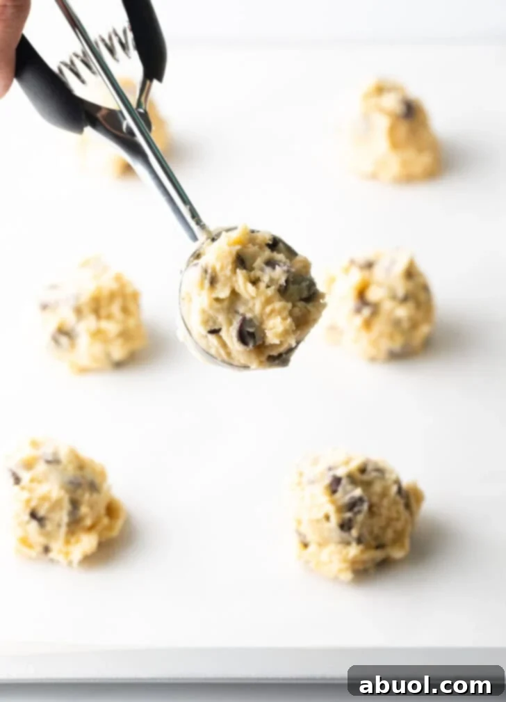 Salty Sweet Crunch Cookies 10 Scooped potato chip cookie dough balls arranged on a baking sheet, ready for the oven.