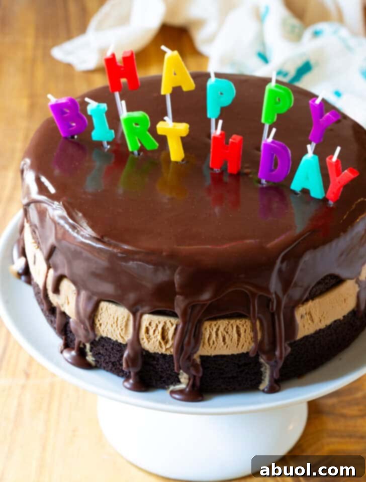 Homemade Ice Cream Cake Bliss 12 Chocolate and caramel ice cream layered cream cake coated with glossy icing and Happy Birthday candles on top.