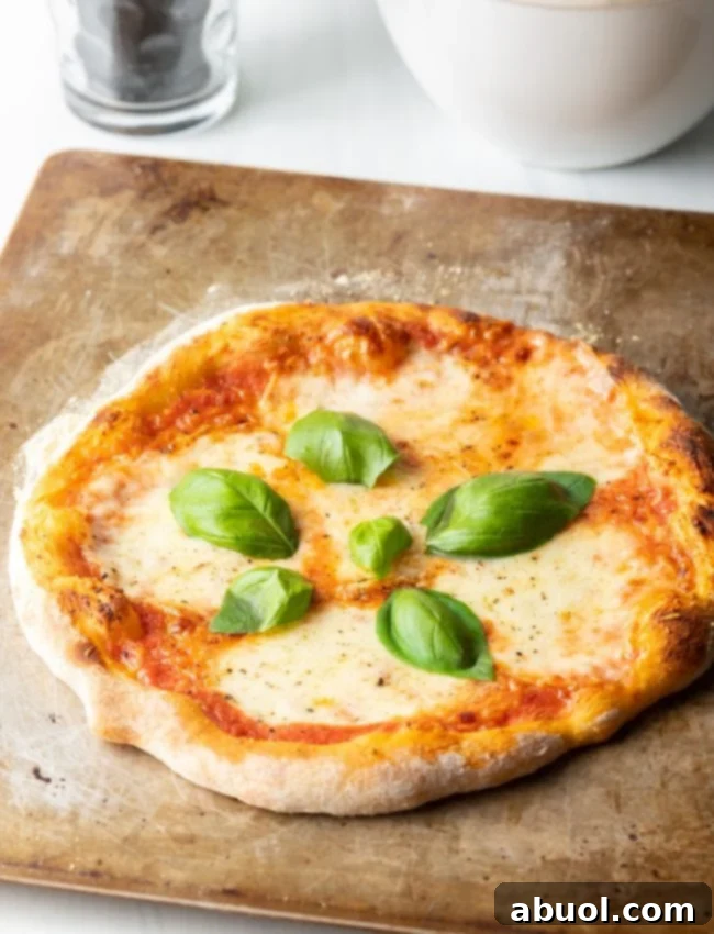 Crafting Perfect Neapolitan Pizza Dough 17 Baked Neapolitan pizza with fresh basil leaves.
