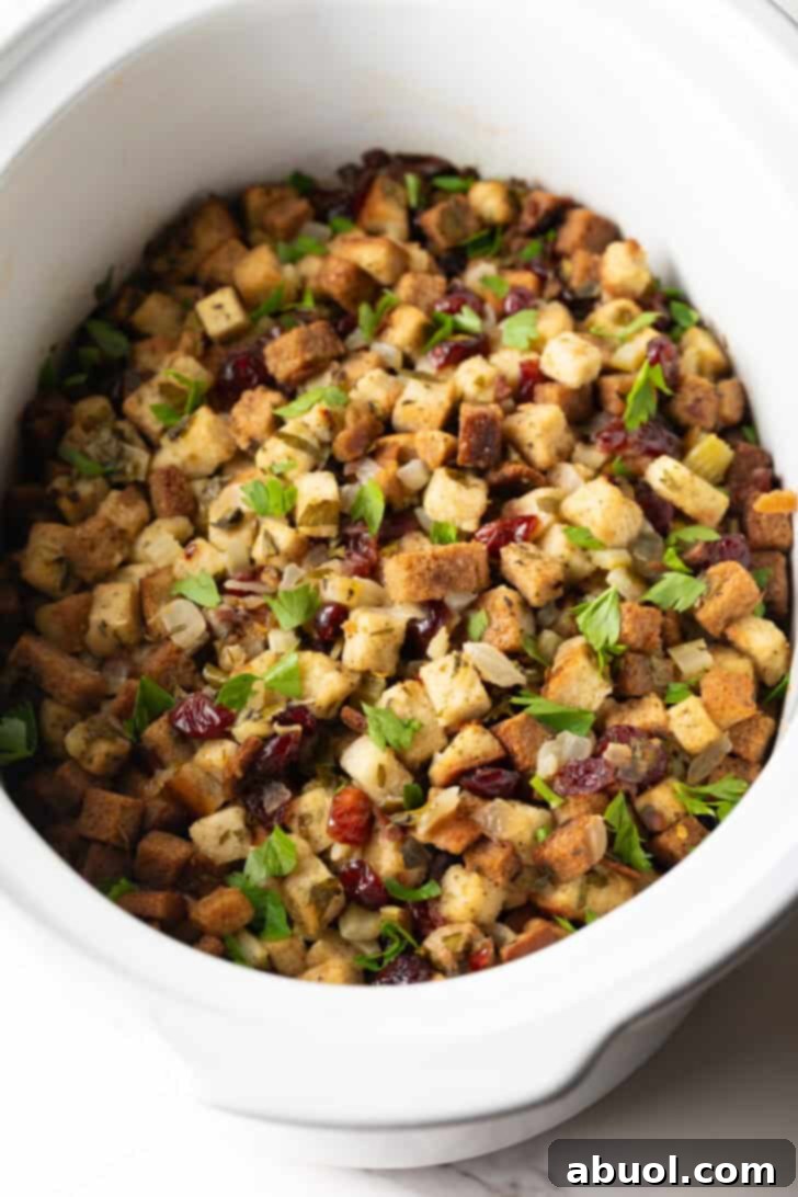 Overhead shot of crock pot stuffing recipe in a white crock pot.