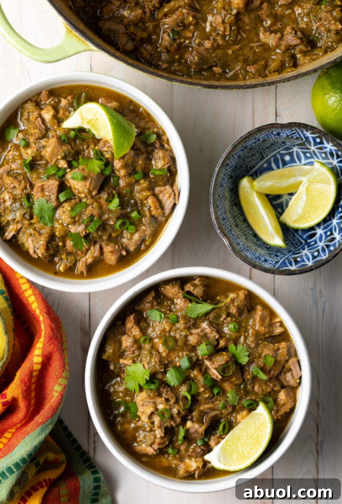 Bowls of new Mexican green chile with lime wedges on the side. 