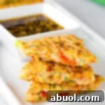 A delicious Korean pancake (Pajeon) served with dipping sauce.