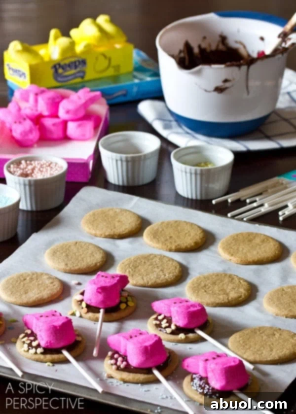 Simple Easter S'mores Cookies on a stick - Unbaked graham cracker cookies with lollipop sticks inserted, ready for the oven.
