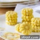 Finished Lemon Spritz Cookies, layered with lemon cream, beautifully presented.