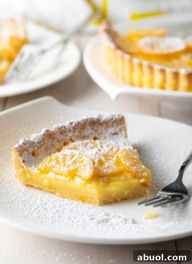 Meyer Lemon Tart cut with fork to expose creamy center
