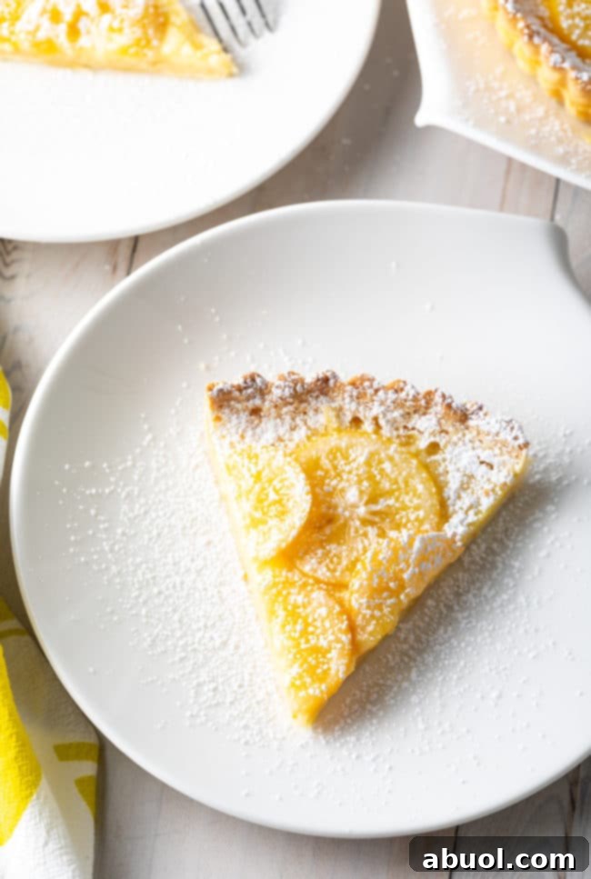 Best Ever Lemon Tart cut and placed on several plates.