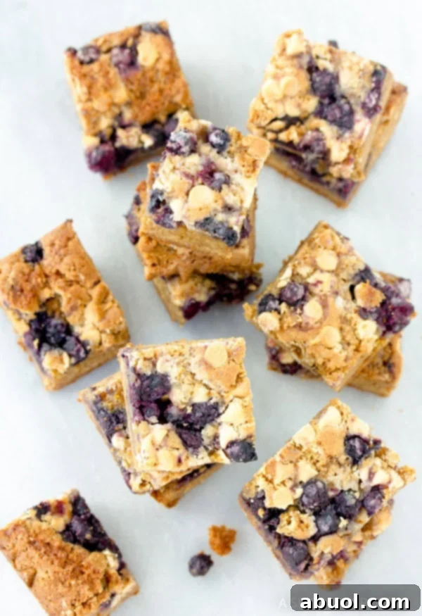 Multiple cut out pieces of Blueberry White Chocolate blondies.
