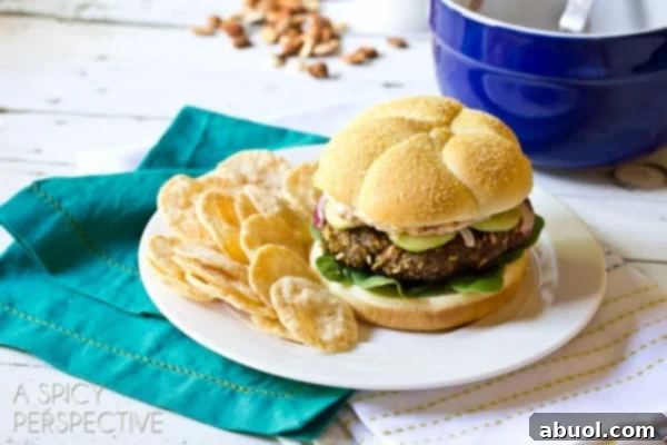 A plated Mediterranean burger alongside a serving of crispy chips, ready for a satisfying meal.