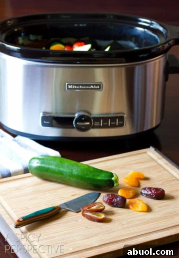 Ingredients being prepped for Slow Cooker Moroccan Chicken, showing chopped vegetables and chicken thighs