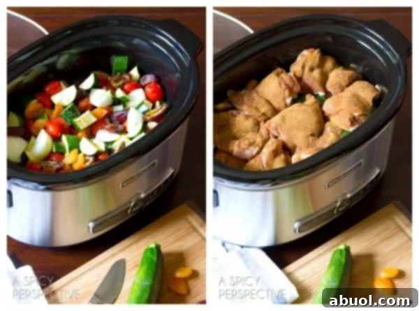 Marinated chicken thighs being placed over vegetables in a slow cooker for Moroccan Chicken