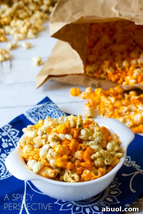 A large white bowl brimming with a perfect blend of golden caramel popcorn and vibrant cheddar cheese popcorn, ready to be enjoyed.