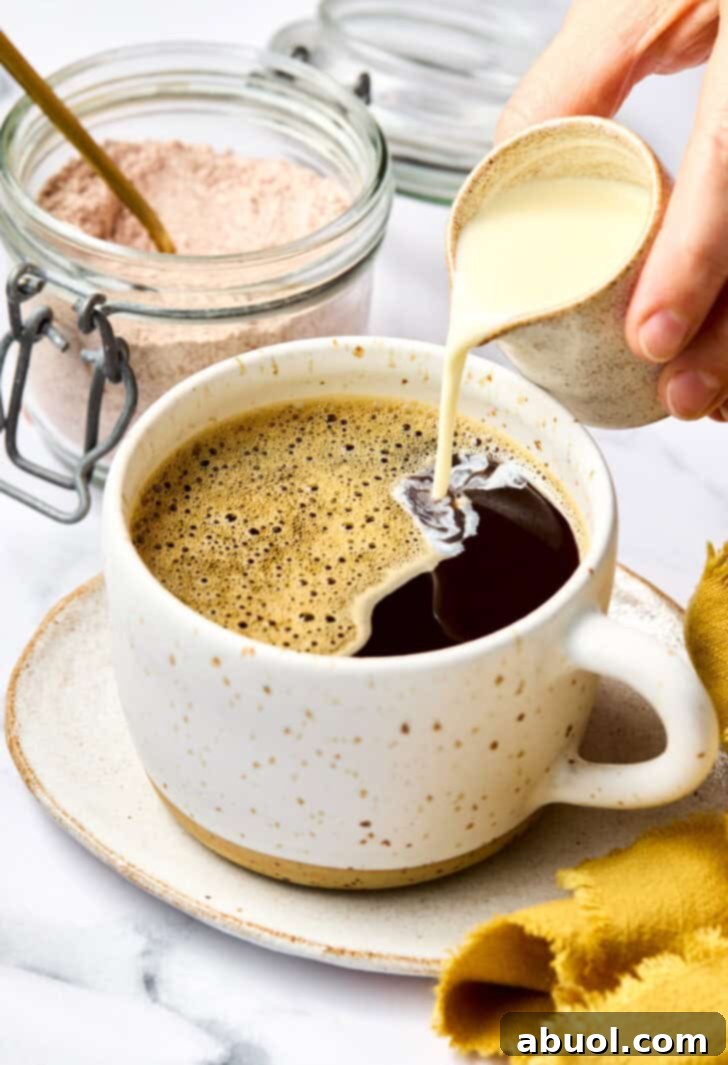 Adding rich, heavy cream to finish the Mexican Mocha, creating a beautiful swirl