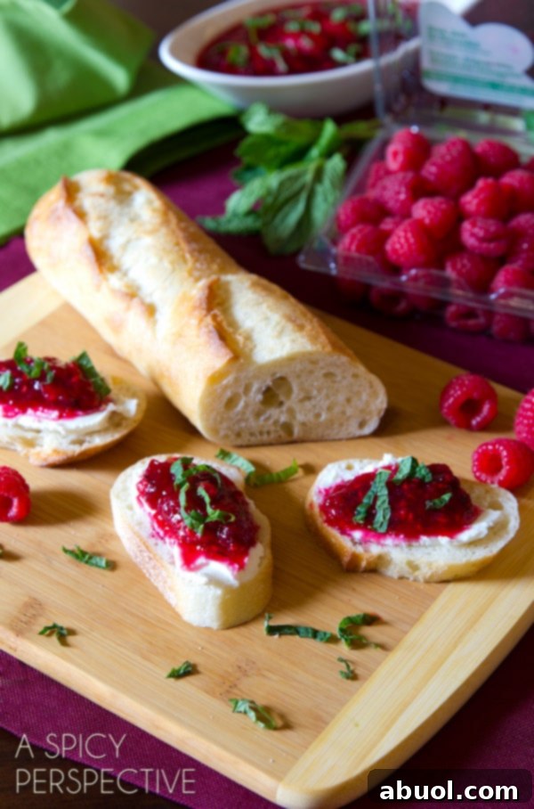 A festive table setting featuring a small bowl of cranberry raspberry sauce, symbolizing the joy and flavors of a holiday meal.