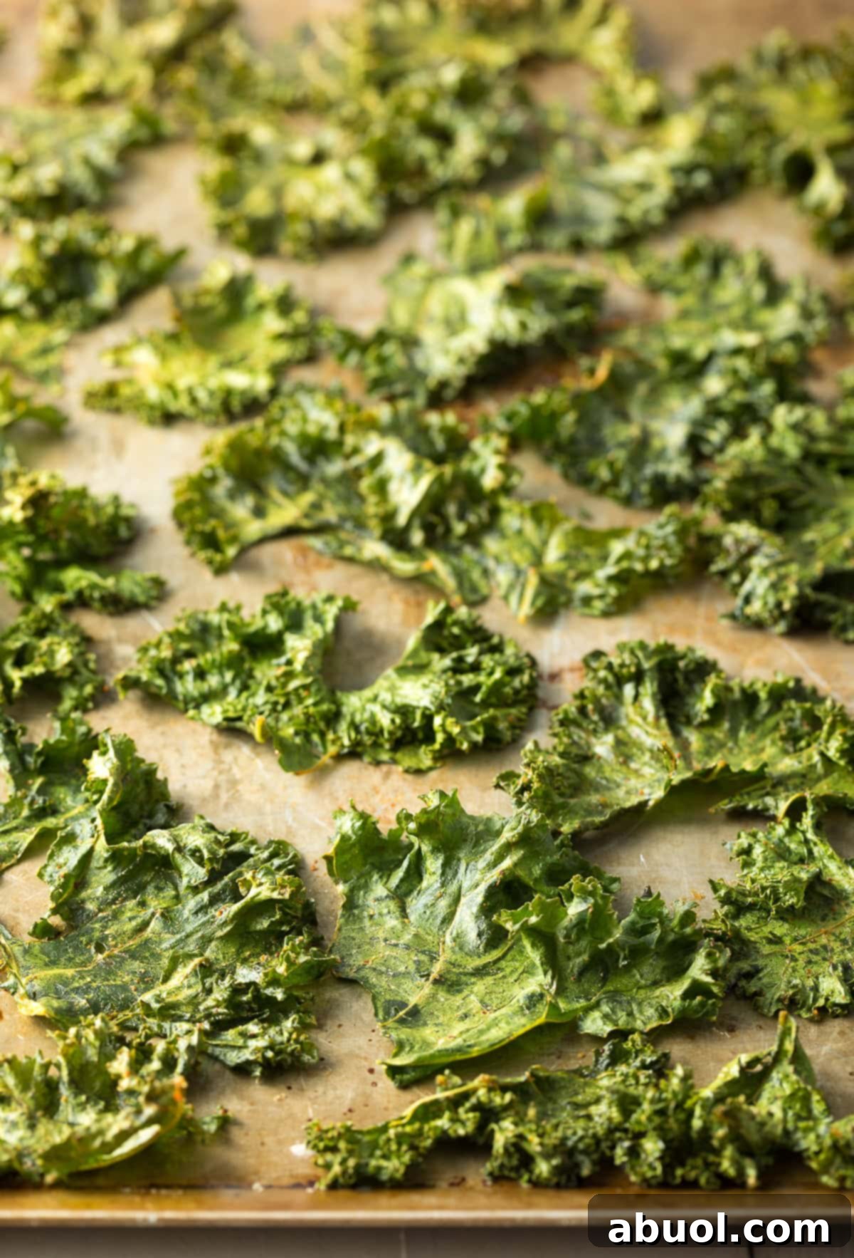 Kale chips on a sheet pan after being roasted.
