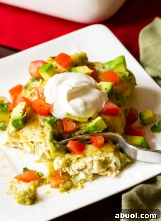 Zesty Salsa Verde Enchiladas 15 Final recipe on a plate ready for eating with a fork in hand, showcasing easy Chicken Enchiladas Verde.