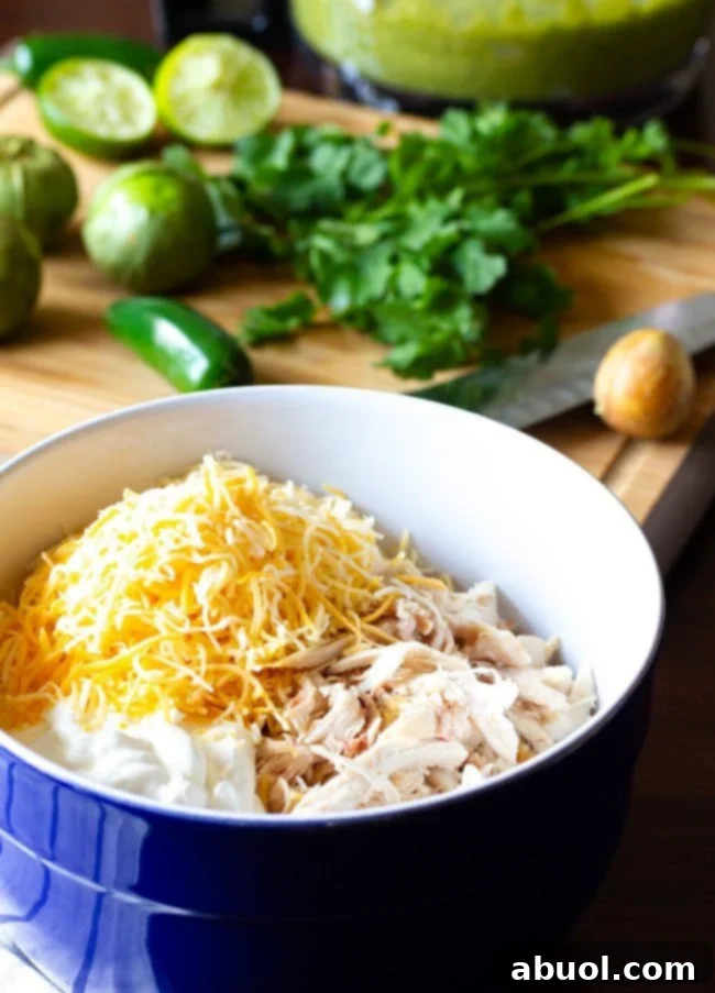 Zesty Salsa Verde Enchiladas 8 Chicken enchilada filling mixed in a bowl, ready for assembly.