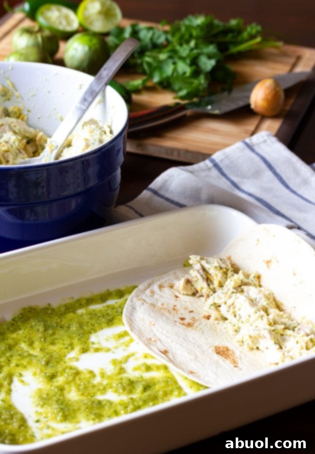Zesty Salsa Verde Enchiladas 10 Assembling enchiladas in a baking pan, with filling being spooned onto tortillas.