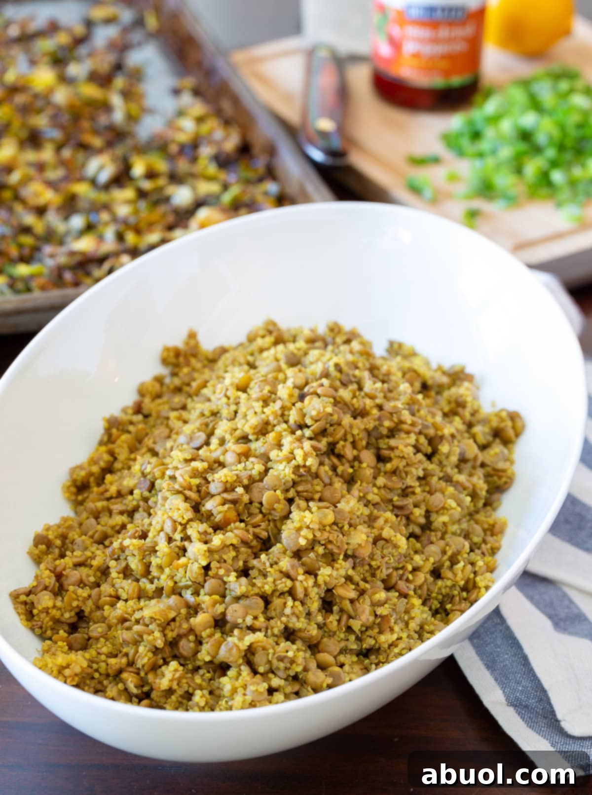 Close-up shot of fluffy quinoa and firm lentils mixed in a bowl, ready for salad assembly.