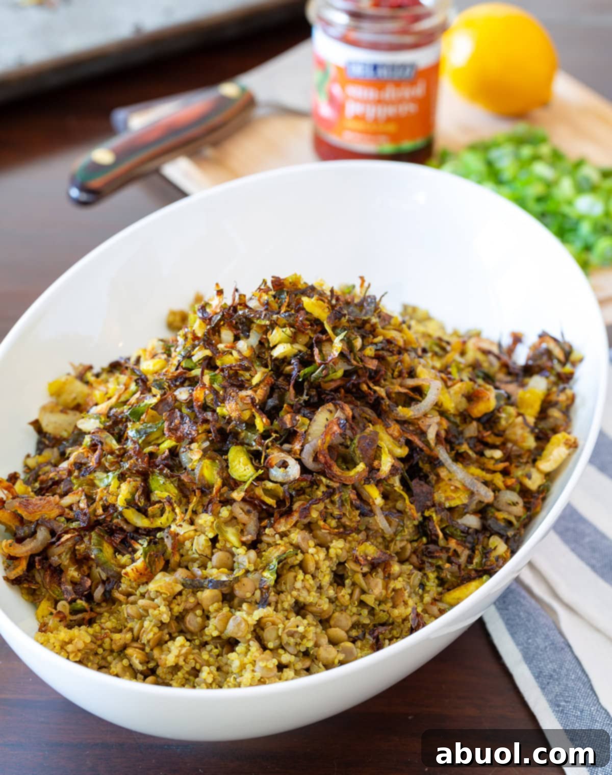 Beautifully plated Quinoa Lentil Salad with roasted Brussels sprouts and red peppers, ready to be served.