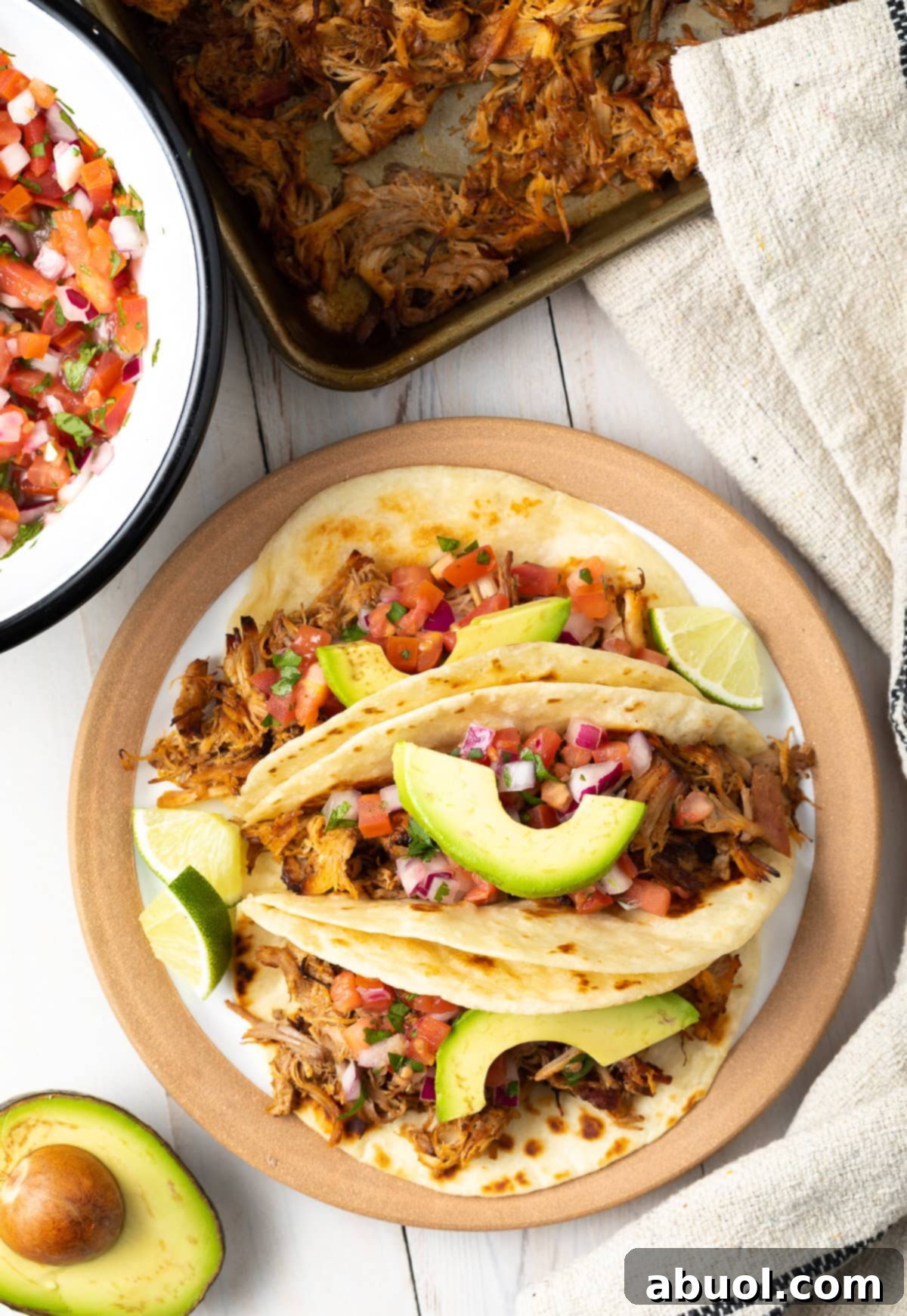 Overhead shot of an easy slow cooker carnitas tacos recipe plated beautifully.