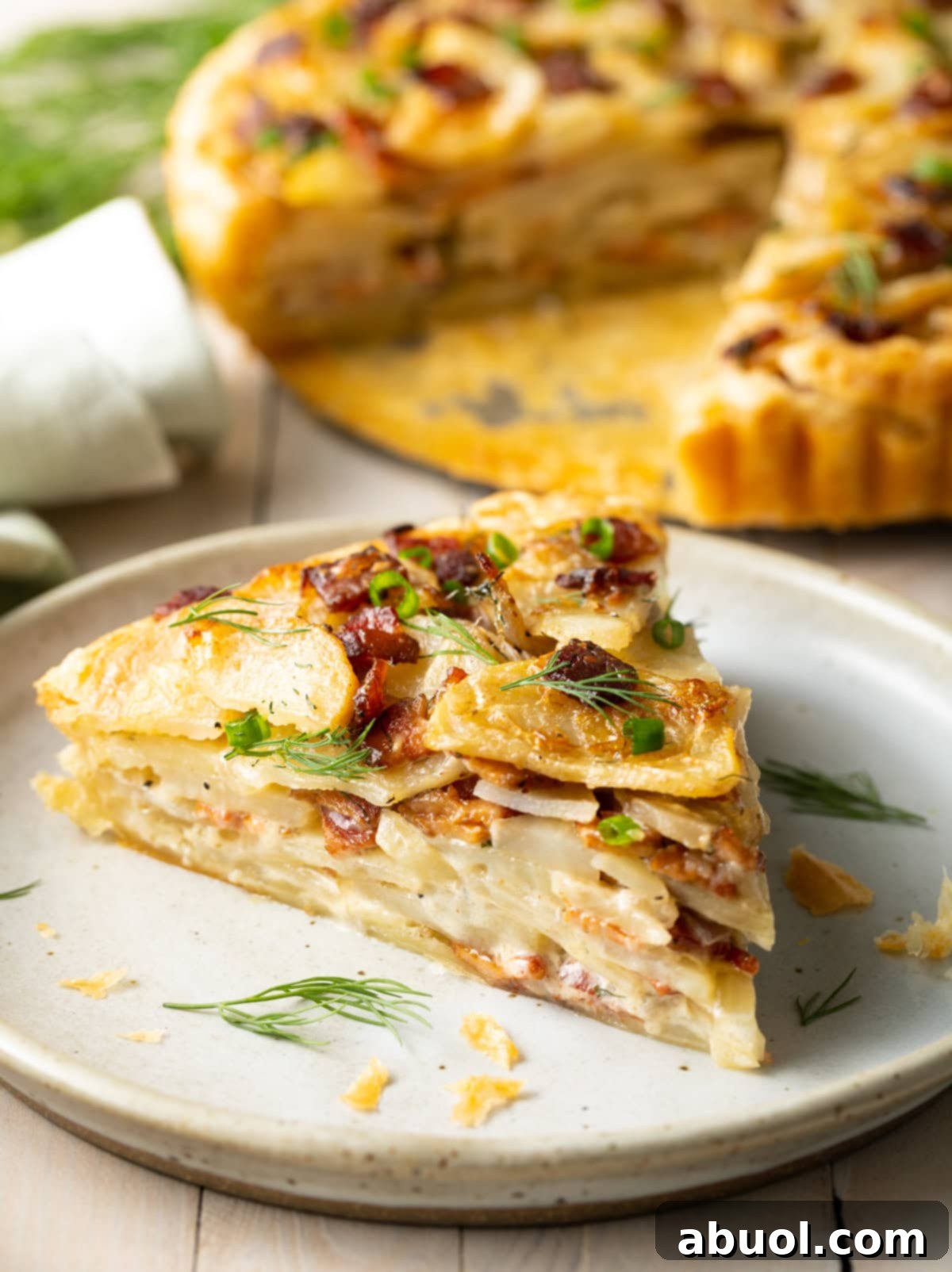 Close-up of a slice of potato pie on a plate, highlighting the delicious textures.