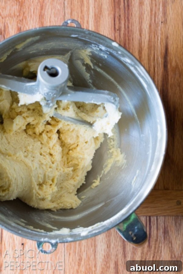 Ingredients for Cornmeal Sugar Cookie batter being mixed in an electric stand mixer.