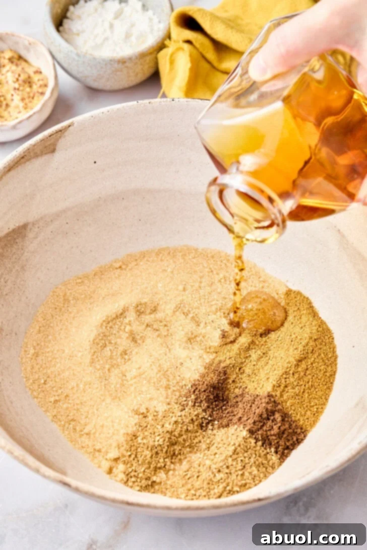 Step-by-step image: Mixing ground spices in a small bowl, preparing them for the baked ham glaze.