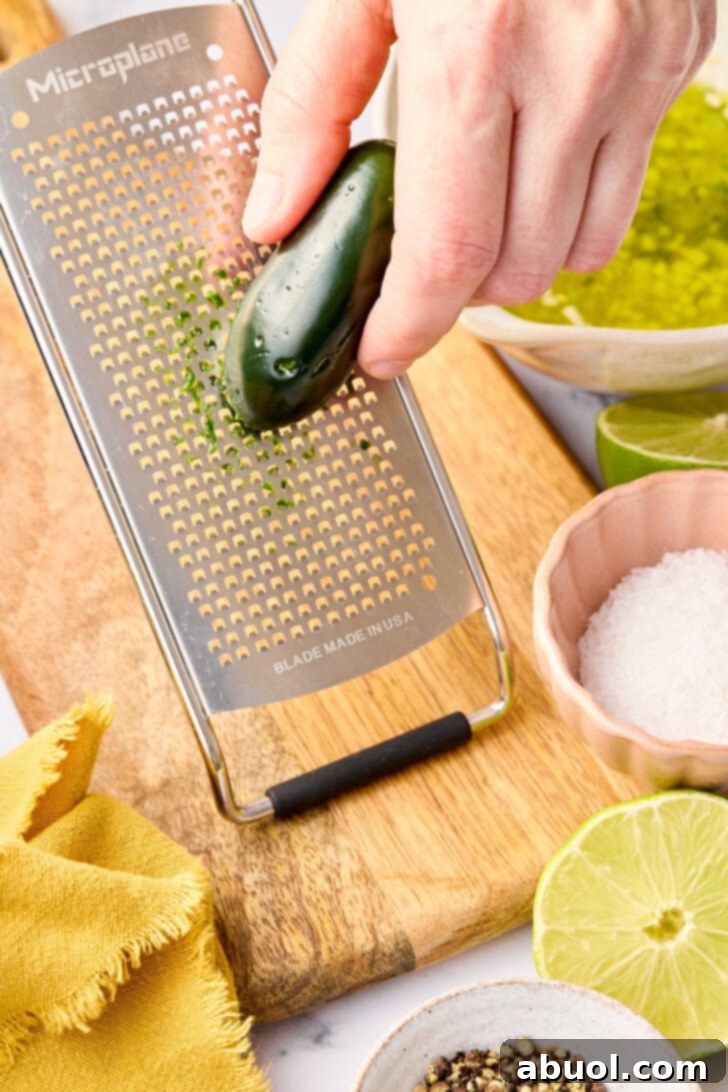 Grating jalapenos for oven salmon recipe.