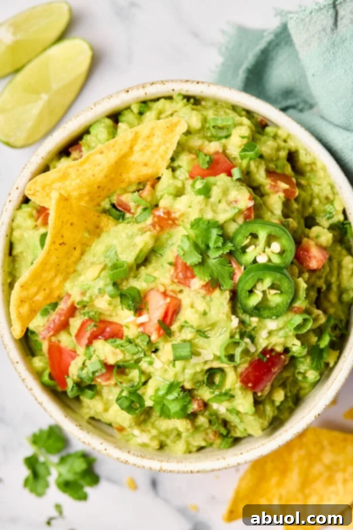 The Guacamole Gospel 3 Top down view of plated guacamole with chips, perfectly seasoned and ready to eat.
