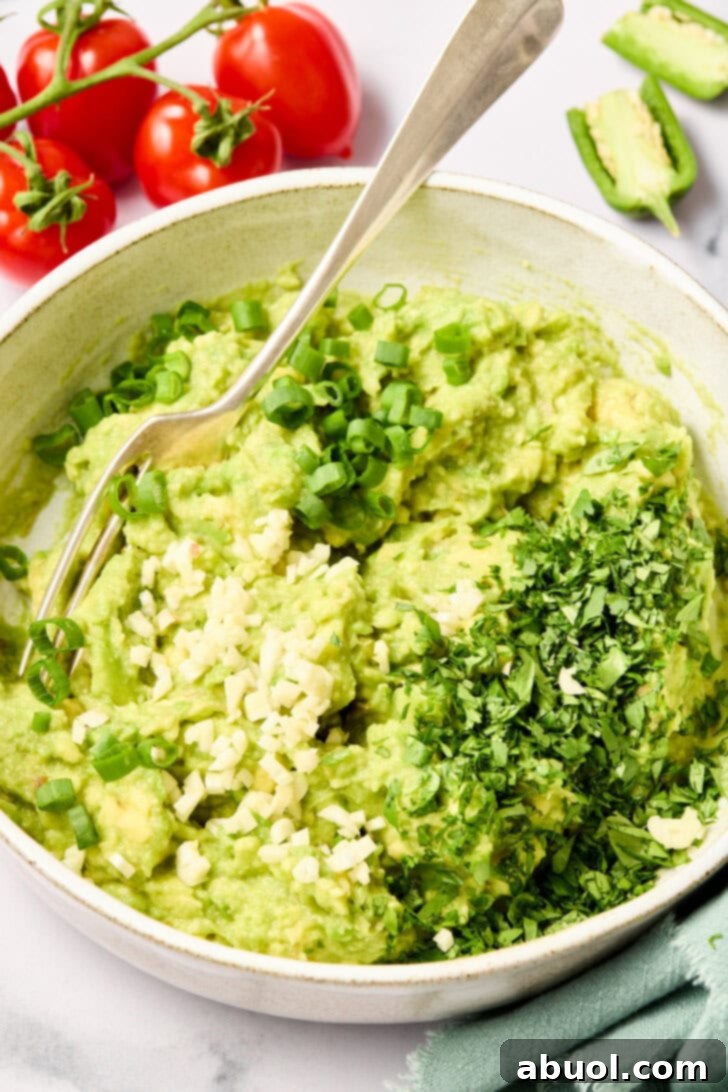 The Guacamole Gospel 7 Fresh herbs and minced garlic being added onto smashed avocado, enhancing the aroma.
