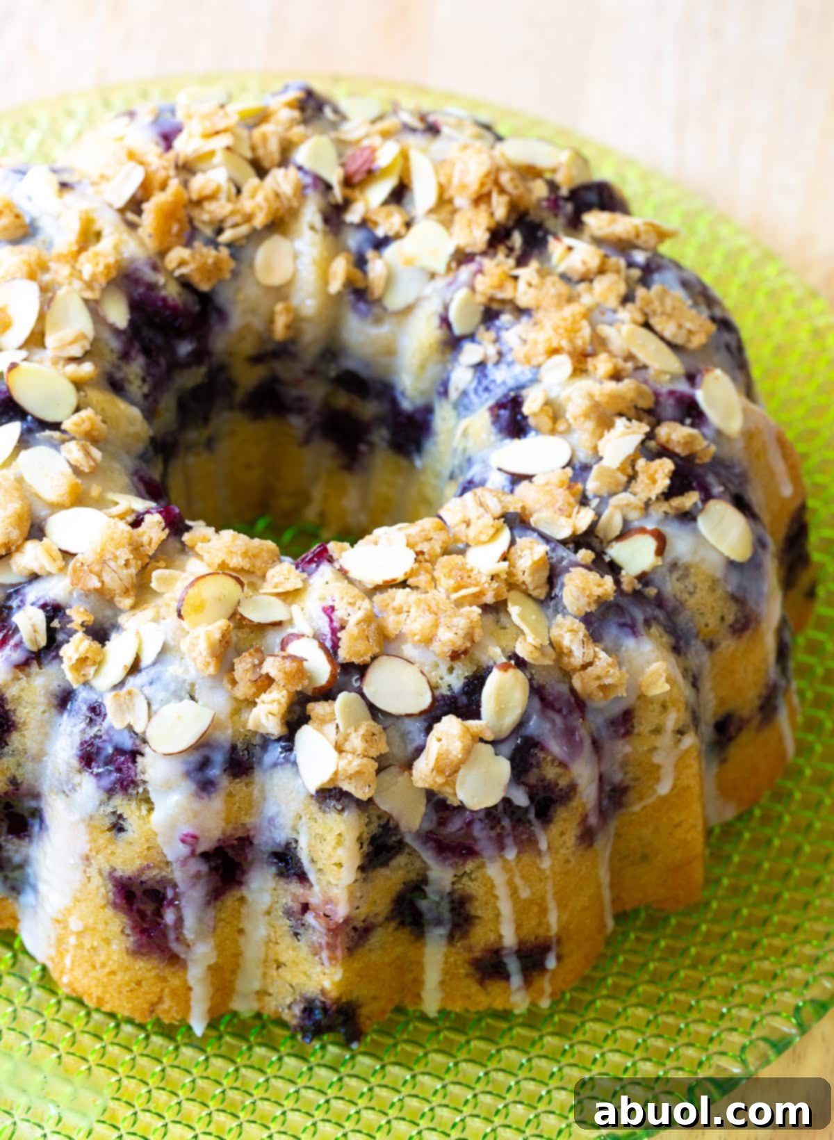 A beautifully glazed blueberry muffin cake with an oat streusel topping.